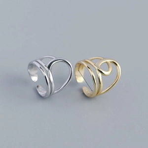 Detail view of gold and silver layered open rings with 16.5mm and 17mm diameter measurements