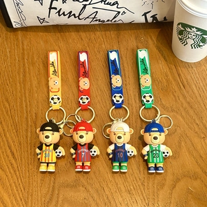 Set of four colorful cartoon soccer bear keychains with jersey numbers and football charms