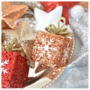 Macro shot of sparkling sequined star and gift box ornaments for Christmas tree decor