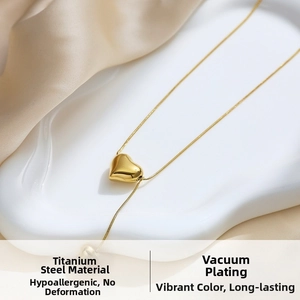 Close-up of gold heart pendant on snake chain made of vacuum-plated titanium steel