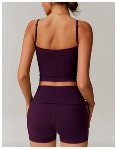 Rear view of deep purple two-piece yoga set with slim crop top and high-waist sports shorts