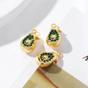 Detail view of 18K gold plated avocado pendants with sparkling green zircon crystals