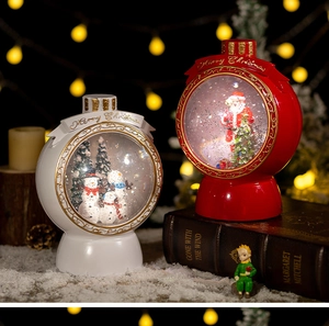 Close-up of festive Christmas snow globes with Santa and snowman inside warm light scenes