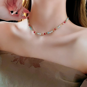 Close-up of colorful crystal beaded necklace with natural stone accents on a model
