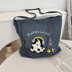Close-up of blue striped canvas tote bag with 3D puppy embroidery and PUPPYLAND text