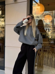 Vista street style di un set con felpa grigia e pantaloni sportivi a righe nere