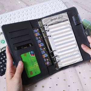 Detailed macro view of gray PU leather budget binder with 6-ring clips and card slots