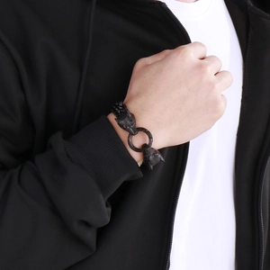 Close-up of men's double wolf head bracelet in black finish on model's wrist