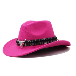 Detail of rose red felt cowboy hat featuring ethnic woven band and silver bull head