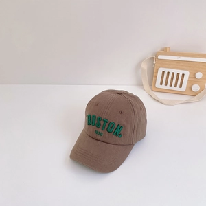 Detailed shot of brown cotton baseball cap with green BOSTON 1630 3D embroidery