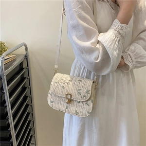 Summer straw saddle bag with green floral embroidery and adjustable leather strap