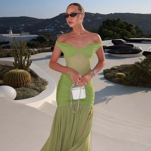 Detail of sheer mesh patchwork and ruched chiffon hem on off-shoulder green maxi dress