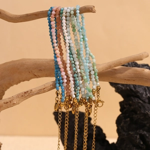 Detailed shot of multi-colored natural stone beaded anklets with gold extender chain