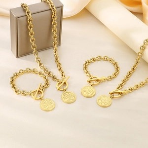 Two-piece golden stainless steel jewelry set featuring tree of life charms and OT buckles