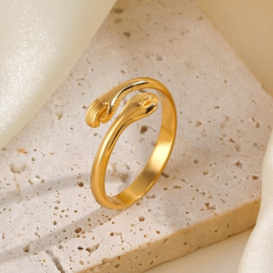 Minimalist golden open ring with cat paw design on aesthetic travertine stone base