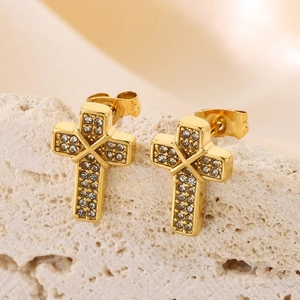 Macro shot of gold cross stud earrings featuring clear crystal zircon stones for women