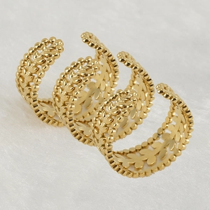 Adjustable hollow golden wheat ear stainless steel rings on a soft white texture
