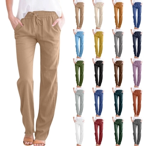 Detail view of cotton linen trousers showing elastic drawstring waist and color variety