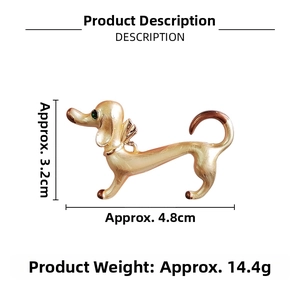 Detailed view of Dachshund brooch with gold metal and green gemstone eye accents
