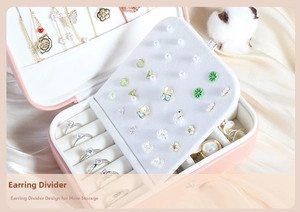 Detail of pink PU leather jewelry box with earring studs panel and ring slots
