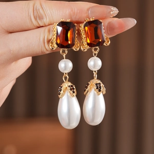 Baroque vintage earrings featuring amber gemstone and tiered pearls in gold setting