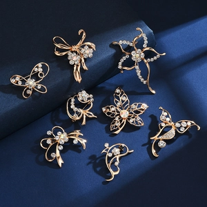Elegant gold brooches set with crystal rhinestones in flower and butterfly designs