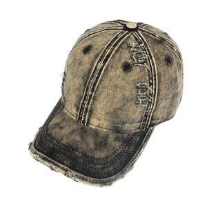 Vintage distressed denim baseball cap with washed khaki finish and ripped details