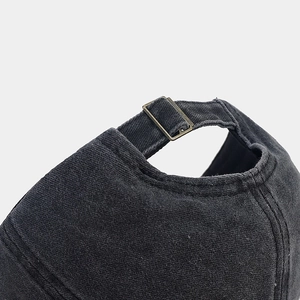 Macro detail of charcoal cotton baseball cap with adjustable antique bronze metal buckle