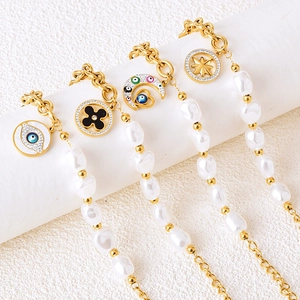 Fashion pearl gold chain bracelet featuring evil eye, star and moon charms