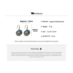 Detail view of vintage gold plated earrings with blue enamel flowers and pearl accents