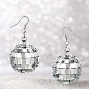 Close-up of silver disco ball earrings with faceted mirror finish on a sparkly base