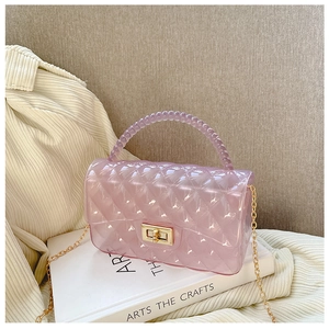 Pink transparent jelly bag with diamond quilting, gold chain strap, and beaded handle detail