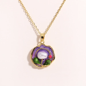 Detailed macro of gold flower pendant with purple enamel and a real freshwater pearl