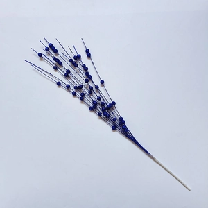 Macro detail of artificial Christmas glitter berries in deep blue on white stem