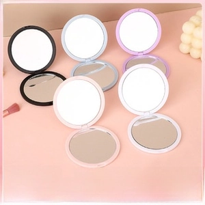 Detailed view of portable macaron colored foldable makeup mirrors in five soft pastel shades