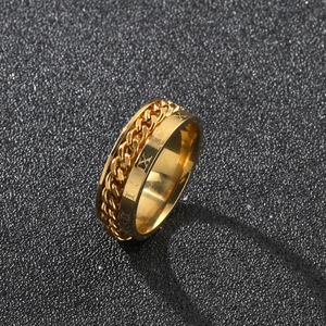 Detailed macro view of gold stainless steel ring with spinning chain and Roman numerals