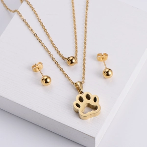 Three-piece gold titanium steel jewelry set featuring a hollow paw pendant and ball earrings