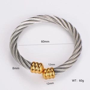 Detailed view of two-tone steel cable bangle with silver ropes and golden ring caps