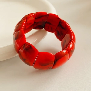 Close-up of red marble pattern acrylic geometric stretch bracelet with high gloss finish