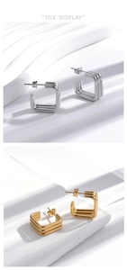 Macro detail of geometric square earrings in gold and silver with triple line design