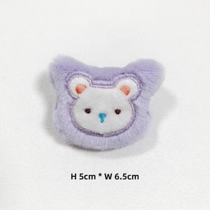 Macro shot of purple plush bear accessory with white embroidery, size 5cm by 6.5cm