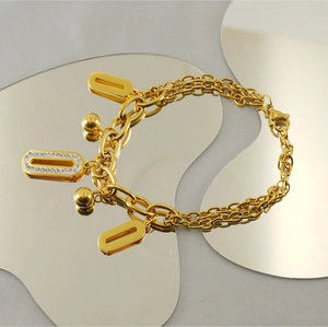 Détail du bracelet en acier inoxydable 18K avec breloques en diamant sur miroir