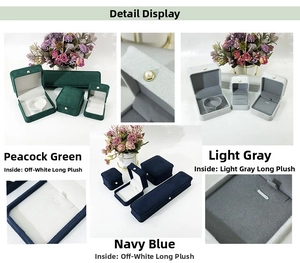 Detail of luxury velvet jewelry boxes in green, grey and blue with plush lining