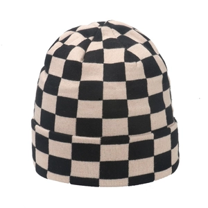 Classic black and white checkered knit beanie hat with thick ribbed cuff for winter