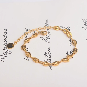 Golden coffee bean chain bracelet with adjustable link and small round pendant charm