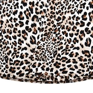 Detailed macro view of soft satin fabric featuring classic leopard print and neat brown stitching
