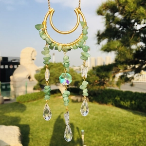 Detail of moon suncatcher with green crystal stones and clear water drop pendants