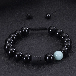 Detailed view of Scorpio zodiac bracelet with black onyx beads and blue accent stone