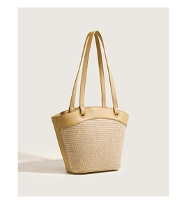 Detail showing the straw weave texture and yellow PU leather straps of this tote bag