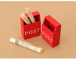 Miniature red wooden dollhouse mailboxes with post text and tiny rolled newspapers